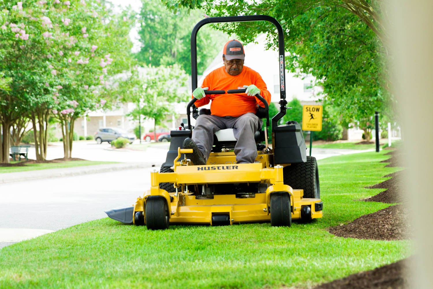 BTC crew member mowing a lawn